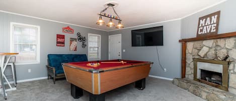 Man Cave with Pool table, 75 inch TV and futon 