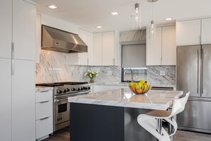 Full kitchen with Dishwasher, Microwave and Refrigerator. Granite finishes