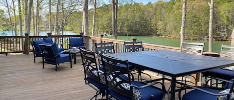 Large deck with dining table seats 8 and conversation set. 