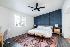 Board and batten accent wall along with king size bed in the master bedroom