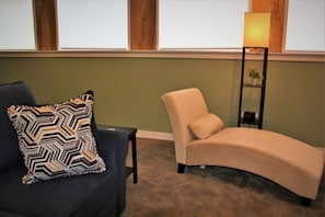 Sink into the plush seating arrangements as you enjoy the natural light streaming through the windows, creating a warm and inviting ambiance.