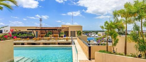 A bridge taking you across the pool to the open-air seating area