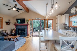 Kitchen and living room. Open french doors for more outdoor living.