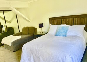 Queen bed and child size couch. Flat screen TV across from bed in this cozy room
