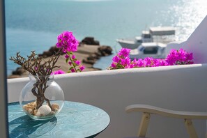 Take in the vibrant colors and peaceful views from the balcony, surrounded by blooming bougainvillea and the soothing sound of waves in the distance.
