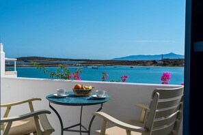 Admire serene coastal views from your upper-floor suite, offering a panoramic perspective of the shimmering sea and charming surrounding landscape.