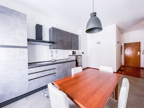 Spacious living room with kitchenette, sofa bed and flat screen TV