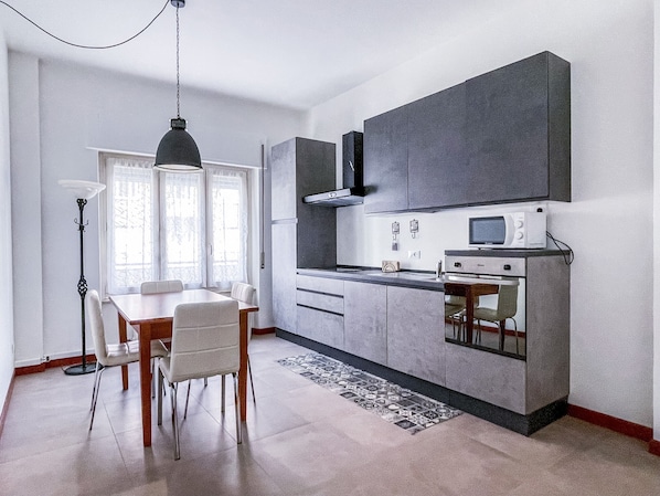 Spacious living room with kitchenette, sofa bed and flat screen TV