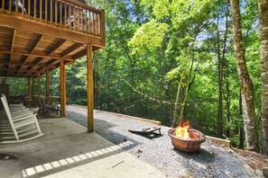 Tranquil backyard with 2 level deck, fire pit, corn horn string lights and chair