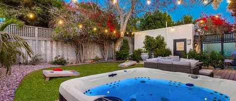 Step into your personal paradise with a backyard oasis, featuring a hot tub that seats seven—an ideal retreat for ultimate relaxation.