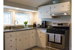 Fully stocked kitchen with gas cooktop and dishwasher.  Fresh flowers too!