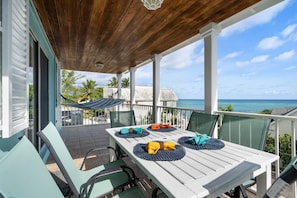 Enjoy having food and drinks on the porch as you listen to the waves.