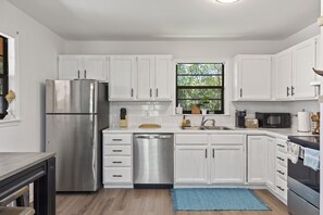 Fully functioning kitchen featuring stainless steel appliances