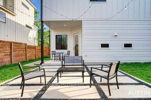 Seating in the backyard with string lights above