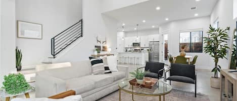 Living room with queen sleeper sofa and large smart TV