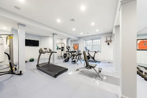 gym with treadmill, cross trainer, weight machine, peloton, boxing bag