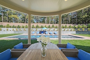 view from living room towards pool, outdoor dining