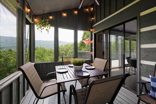 Outdoor dining in a screened in porch is perfect on any day!