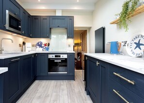 Kitchen with cooker, hob, microwave, dishwasher, undercounter fridge/freezer