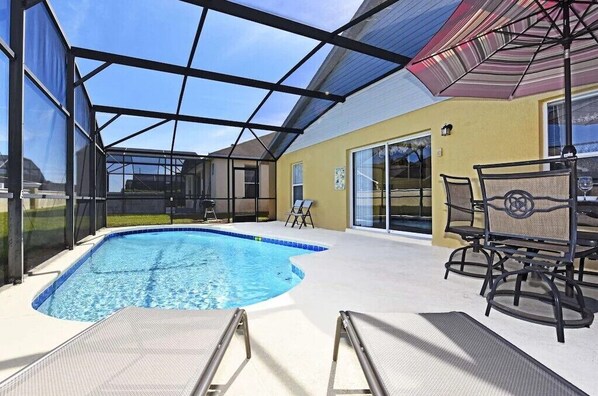 Private screened pool with sunny deck and lounge chairs—perfect for relaxation.