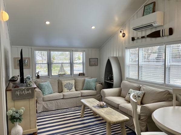 Comfortably cozy living room with coastal decor and plenty of light!