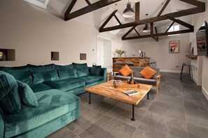 The Steading at West Lyham - TV and bar room with large corner sofa, bar with stool seating and large TV (beer pumps not available for guest use)