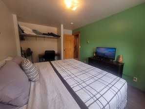 Bedroom 1 w/ new dresser and TV. Desk located on the opposite side of the room.
