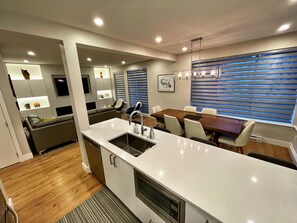 Open concept kitchen with quarts countertop and stainless steel appliances