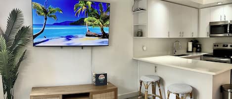 Enjoy relaxing in front of our 65-inch smart TV in our living room.