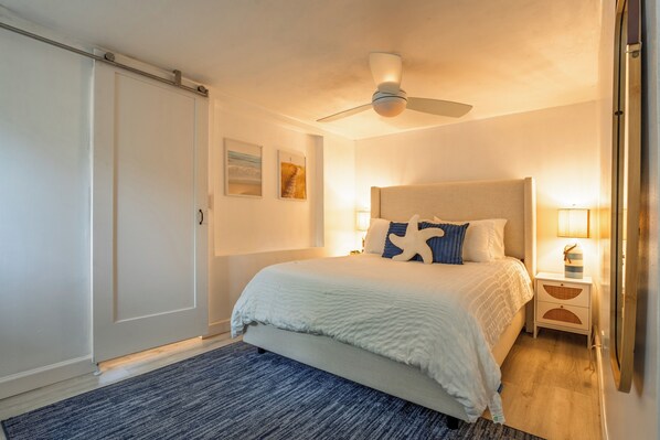 Cozy Coastal Bedroom with Luxury Mattress and 55" Smart TV.