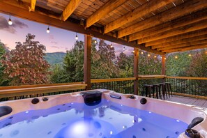 Hot tub located on the lower deck with views of foliage and the Smoky Mountains 