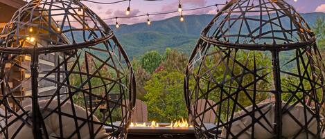 View of the mountains from the hanging egg chairs in the firepit area.
