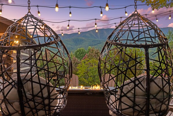 View of the mountains from the hanging egg chairs in the firepit area.