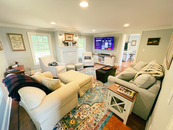 Living room seats the entire family alongside a 65" smart TV
