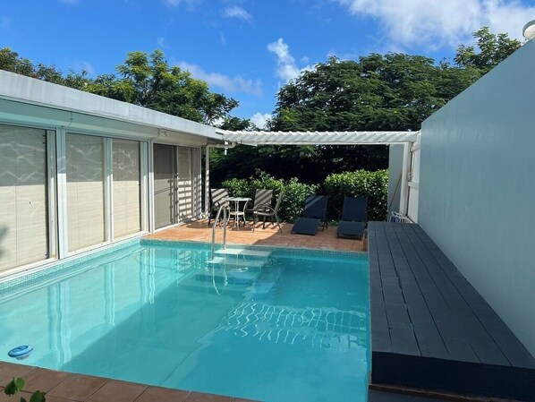 Beautiful remodeled pool with glass tile and graduated steps for easy access.