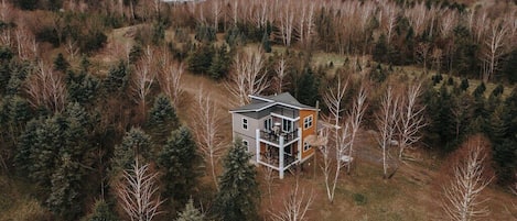 The off-the-grid Chalet lies on 60 acres of explorable woods and farmland.