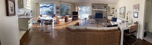 Pano view of spacious living room, windows overlooking lake