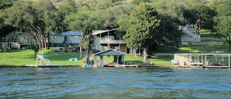 House and boat dock in center, view from across cove.