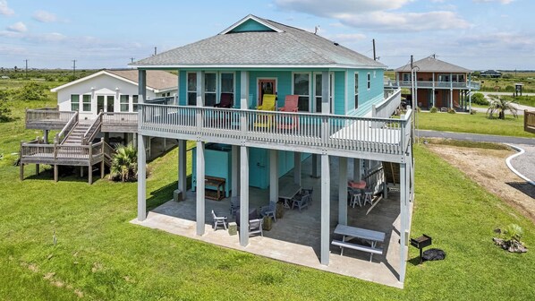 Front view of the beach house. The four large deck chairs will help you relax and enjoy the breeze.