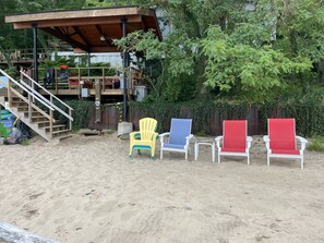 Photo taken from the lake MI water showing the beach, chairs and cabana deck.