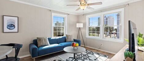 Bright living room with smart tv and dining area