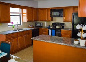 Fully kitchen with Coffee Station, toaster, Stove, Oven, Microwave, Refrigerator
