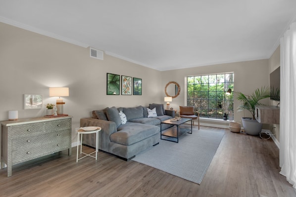 The living room has a comfortable sectional sofa with a seat for everyone.