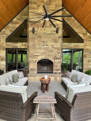 Large Covered Outdoor Porch Sitting Area w/river view and wood burning fireplace