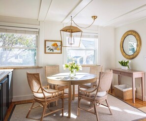 Elegant dining space adjacent to the kitchen, comfortably seating four. Additional bar seating in the kitchen accommodates three more guests.