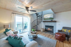 Angle of living area with fireplace & Smart TV
