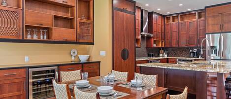 Comfy chairs surround the dining table right next to the kitchen!