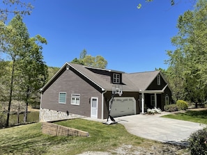 street view of home with pond in background