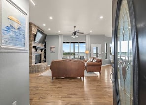 Living room offers seating for nine around a wood burning fireplace.