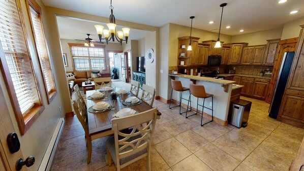 Entryway view of dining area, kitchen, and living room in the background.